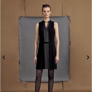 Etcetera black dress with leather trim and delicate chain at neckline.